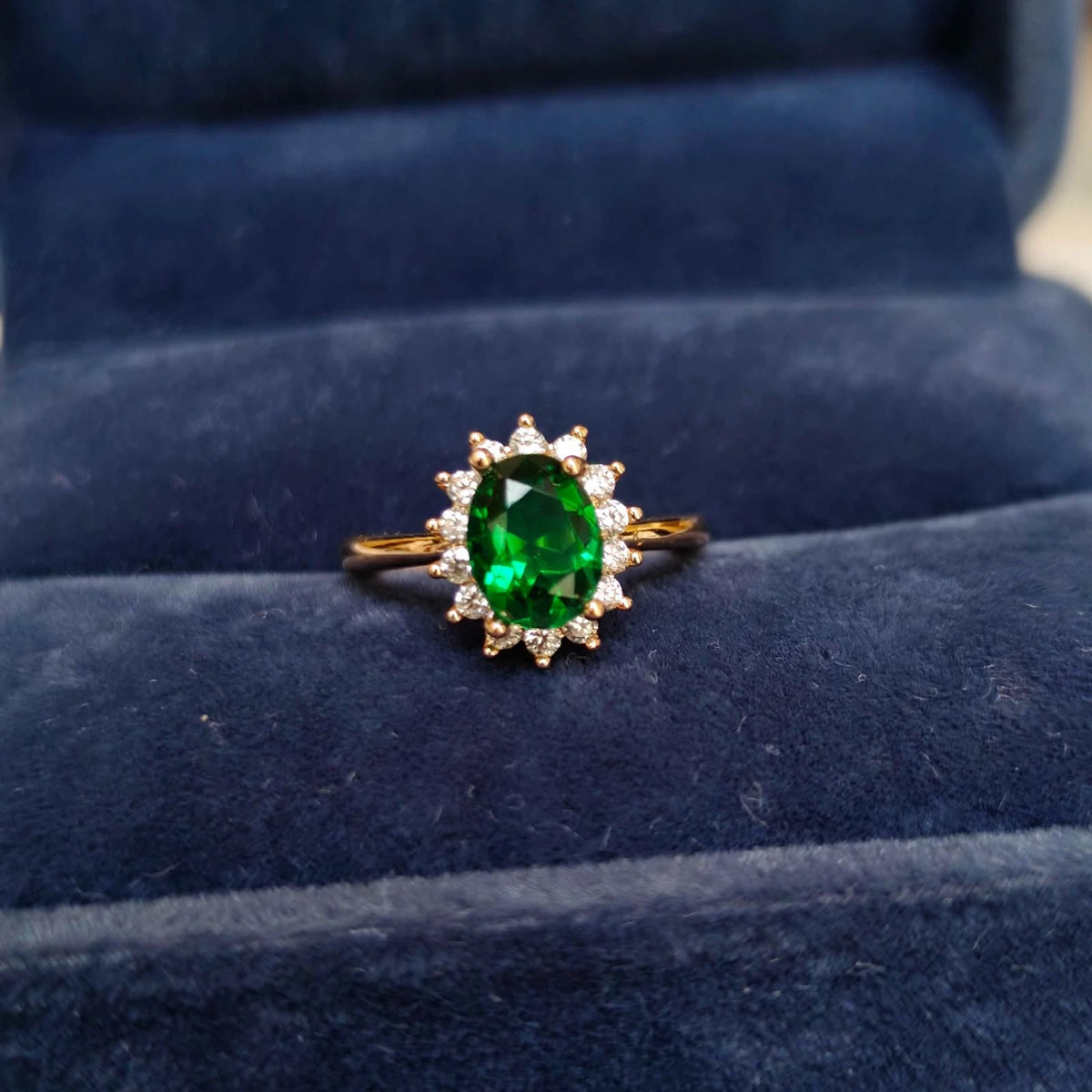 Emerald Green Oval Halo Adjustable Ring in blue velvet ring box