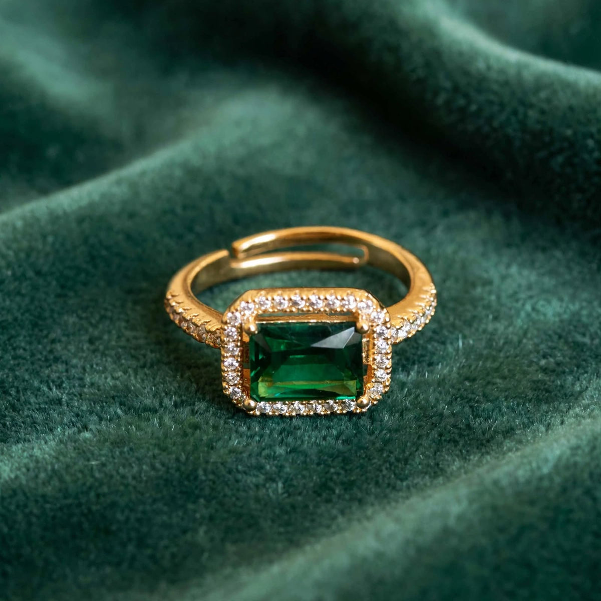 Emerald Green Emerald-Cut Crystal Halo Adjustable Ring on green velvet surface