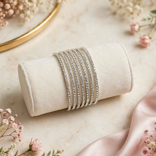 Clear Diamond Rhinestone Silver Elastic Bracelet Set of 6 on marble surface with floral backdrop