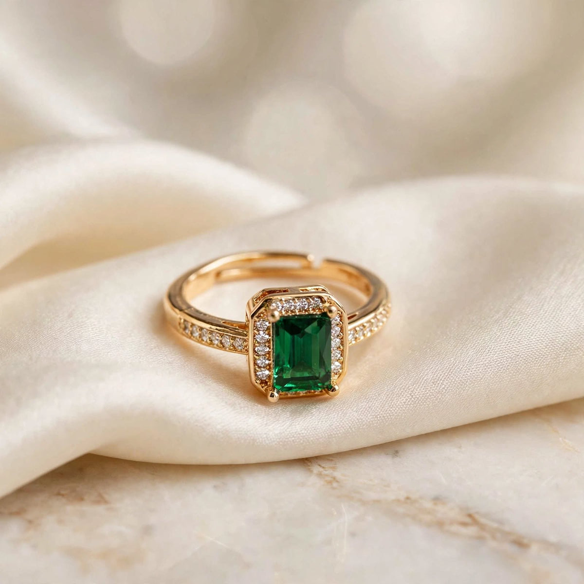 Emerald Green Emerald-Cut Crystal Halo Adjustable Ring in Rose Gold on ivory silk surface