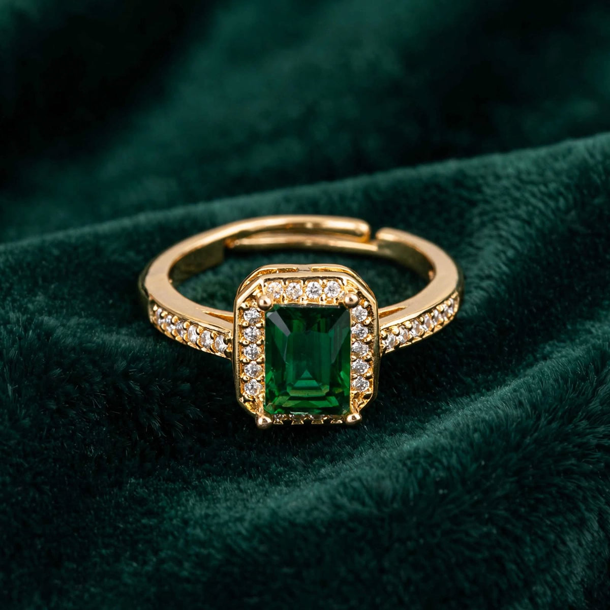 Emerald Green Emerald-Cut Crystal Halo Adjustable Ring in Rose Gold on green velvet surface